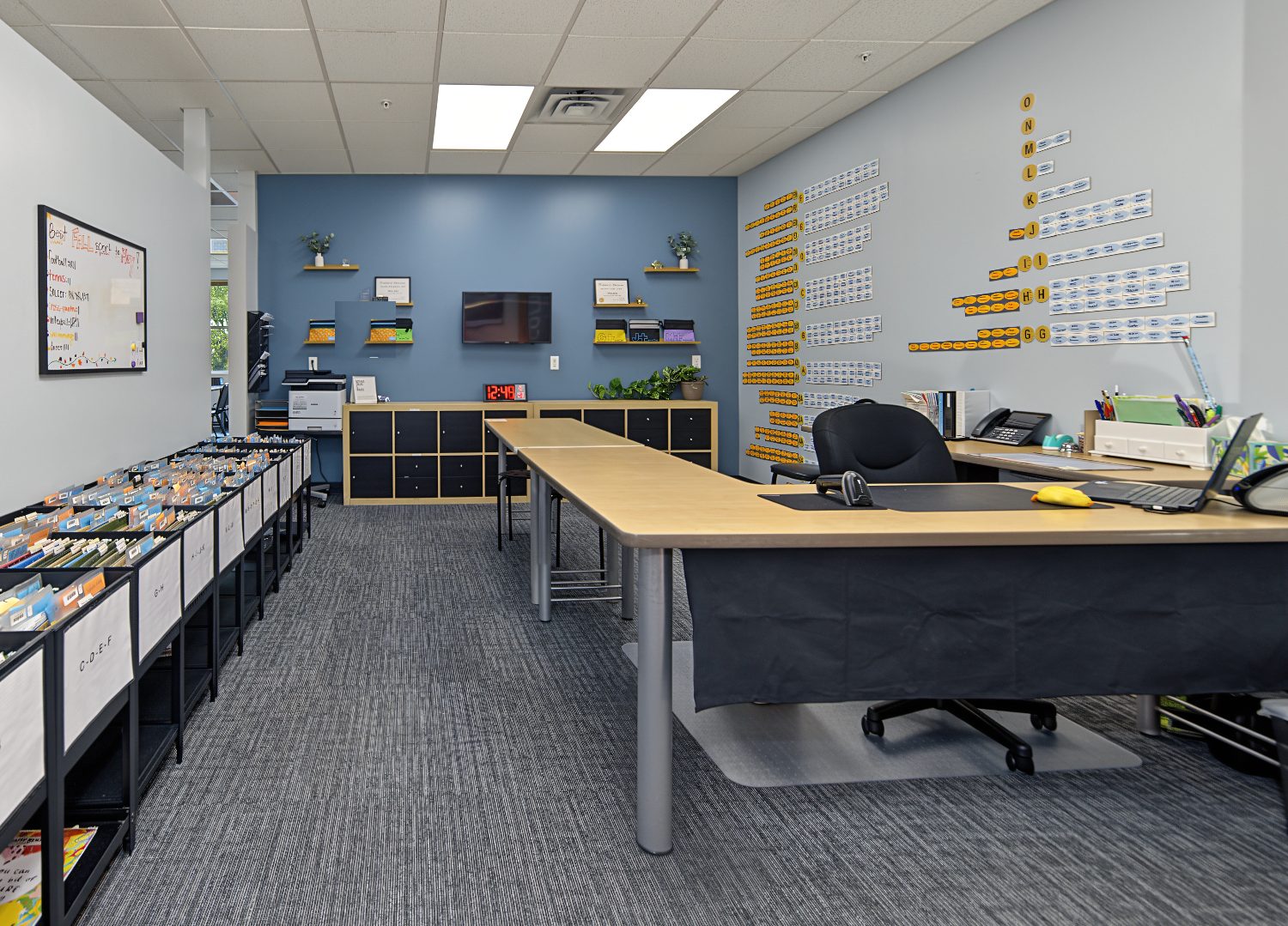 Check-in desk and the student progress wall, where students track every level